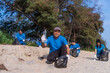 © BJ Day Stock - Plastic pollution and environmental problem concept. Happy asian diverse group of volunteers with garbage bags wearing blue t-shirt and cleaning plastic on the beach. Volunteers collecting trash.