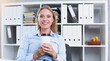 © H_Ko - Smiling business woman drinking coffee from a paper cup in the office portrait looking into the camera holding in her hand and resting during a break.