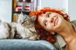 © larisikstefania - portrait red-haired attractive young woman with fluffy big cat