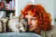 © larisikstefania - portrait red-haired attractive young woman with fluffy big cat