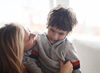 Wall Mural - Love, hug or mother and son in house with tickle, fun or morning games while bonding in their home together. Safety, laughter and kid with mom in a living room with support, protection and security