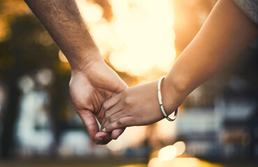 couple, closeup and holding hands outdoor for commitment, relationship and date together with loyalt