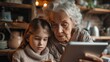 © visoot - An elderly woman in the kitchen uses a tablet with her granddaughter. Generative AI.