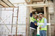 © offsuperphoto - workers or architects working on tablet and pointing up to something at construction site