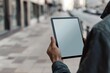 © CogniLens - Display mockup from a shoulder angle of a adult man holding a tablet with a fully grey screen