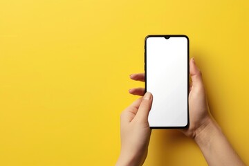 A blank screen smartphone isolated on a yellow background with space for design.