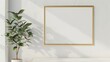 © AkuAku - Gold frame mockup on white wall with houseplant for artwork display