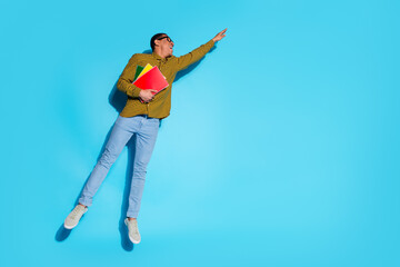 Sticker - Full body photo of attractive young man hold copybooks hang empty space dressed stylish plaid clothes isolated on blue color background