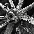 © Justlight - The spokes of the wheel bent and twisted stand testament to the rough terrain it has traversed. Black and white art