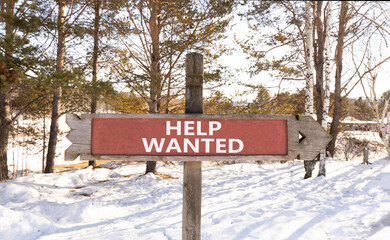 Wall Mural - Help wanted and support symbol. Concept words Help wanted on beautiful wooden road sign. Beautiful forest snow blue sky background. Business, support, help wanted concept. Copy space.