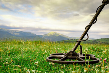 Treasure hunter with a metal detector in the mountains.