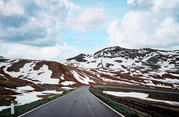 Asphalt road in Alps mountains. Road trip concept. Beautiful landscape.