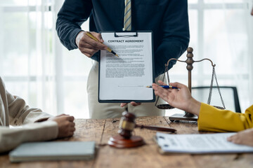 Wall Mural - A man is holding a contract in front of a scale