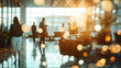 © sornram - Business professionals interact in a modern office lobby with warm lighting and a bokeh effect, creating a dynamic and vibrant atmosphere.