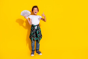 Wall Mural - Full length photo of adorable little boy hold money fan thumb up dressed stylish white garment isolated on yellow color background