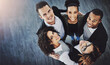© ClearConcept/peopleimages.com - Huddle, office and above portrait of business people for teamwork, collaboration and solidarity in workplace. Company, diversity and top view of men and women for support, community and coworking