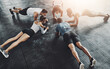 © ClearConcept/peopleimages.com - Class, training and plank in group at gym for workout, core exercise or fitness together indoors. Diverse people, friends and warm up for ab muscle, session and sport for health on gymnasium floor