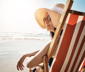 Wall Mural - Beach, chair and calm woman at the ocean for summer, vacation and adventure in nature. Relax, travel and girl person at the sea for tropical, journey or holiday, explore and chilling alone in Cancun