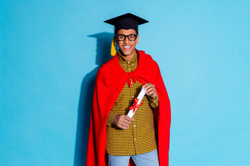 Photo portrait of handsome young guy graduation hold diploma dressed stylish plaid garment isolated on blue color background
