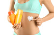 © Pixel-Shot - Beautiful young woman with bottles of sunscreen cream on white background