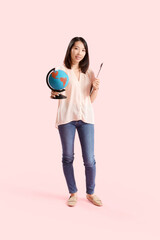 Wall Mural - Asian Geography teacher with globe on pink background