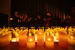 © Ruslan - blurred symphonic orchestra on stage with lots of candles