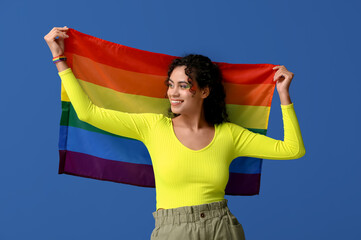 Poster - Young African-American woman with rainbow flag on blue background. LGBT concept