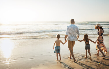 Poster - Back, walking and holding hands with family on beach for summer holiday, weekend or bonding together in nature. Mother, father and children strolling on ocean coast for outdoor vacation in sunshine