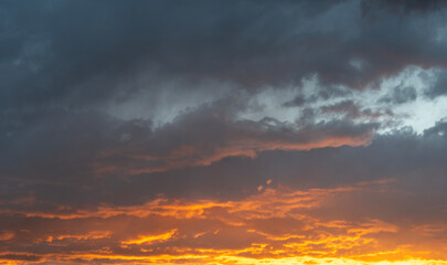 Wall Mural - Sky background. Bright orange sunset sky with clouds.