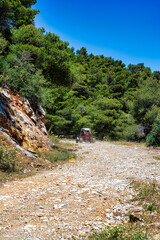 Wall Mural - Off-road vehicle at Hymettus Mountain country road in Athens, Attica, Greece