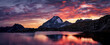 © Jeremy Landscapes - Hi-res mountain peak silhouetted against a fiery orange and pink sunset sky, casting a warm glow