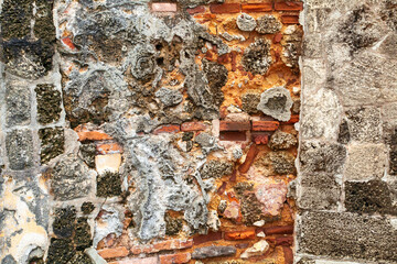 The colorful muralla, or city wall, features two walls of sandstone blocks, filled with sand, mortar, limestone and water found inside of Castillo San Felipe del Morro National Park, in old San Juan
