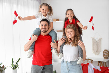 Wall Mural - Happy family with flags of Canada at home