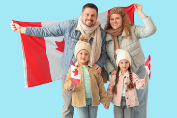 Wall Mural - Happy beautiful family with flags of Canada on blue background