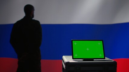 ex KGB FSB secret police agent using mass propaganda tools on green screen laptop to influence population minds. Russian spy silencing online opposition voices using mockup notebook, camera B