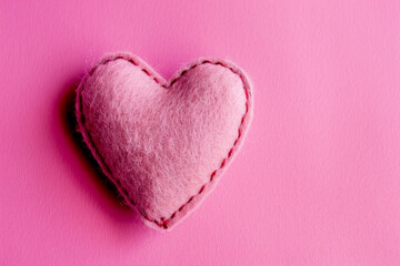 Wall Mural - Valentines day pink felt heart on pink backdrop. Generative AI