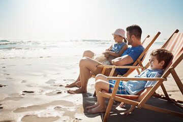 Wall Mural - Family, beach and father with children on chair for holiday, vacation and relax on tropical island. Happy, travel and dad with kids by ocean for bonding, playing and fun outdoors in nature on weekend