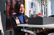 © DC Studio - Clothing store asian woman employee checking trendy belt and tie on display shelf for sale. Shopping center boutique smiling seller examining accessory, managing merchandise inventory