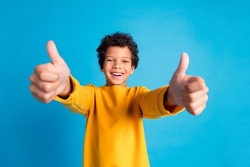 Poster - Portrait of cute small schoolkid thumb up wear pullover isolated on blue color background