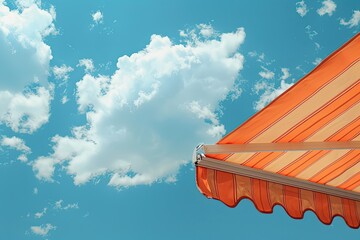 Wall Mural - A blue sky with a cloud and an orange awning. The awning is on the right side of the image