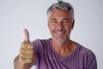 Middle aged man in casual attire giving thumbs up.