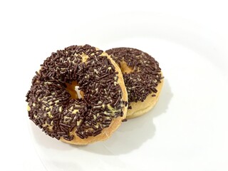 Two pieces of sweet donut with chocolate sprinkles and butter margarine isolated on white background