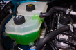 © Евгений Вершинин - Get a closer look at the coolant reservoir of a car, situated in the engine compartment