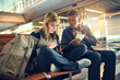 © peopleimages.com - Interracial, couple and checking on tablet at airport for traveling, trip and ticket. People, man and woman with browsing internet for holiday or vacation on adventure, discover and explore world