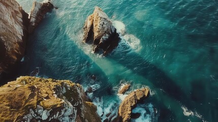 breathtaking aerial view of rugged coastal cliffs jutting dramatically into a turquoise sea showcasing natures raw power and beauty in golden morning light