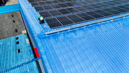 Wall Mural - Worker Technicians are working to construct solar panels system on roof. Installing solar photovoltaic panel system. Men technicians walking on roof structure to check photovoltaic solar modules.