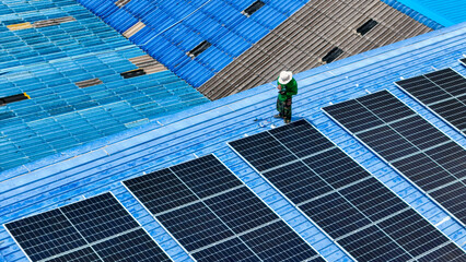 Wall Mural - Worker Technicians are working to construct solar panels system on roof. Installing solar photovoltaic panel system. Men technicians walking on roof structure to check photovoltaic solar modules.