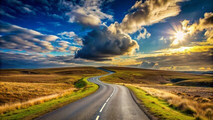 A lone winding road stretches into the distance, divided by a fork in the path, set against a cloudy blue sky.