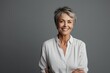© Stocknterias - Cheerful mature woman looking at camera with smile, isolated on grey