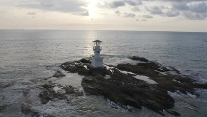 Wall Mural - Aerial top view of lighthouse tower, Khao Lak with seawater, Andaman sea in Phang Nga Bay island in summer season, Thailand. Tourist attraction.